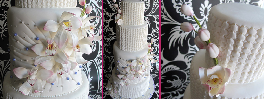 White cake with lavender accents and white orchid sugar flowers
