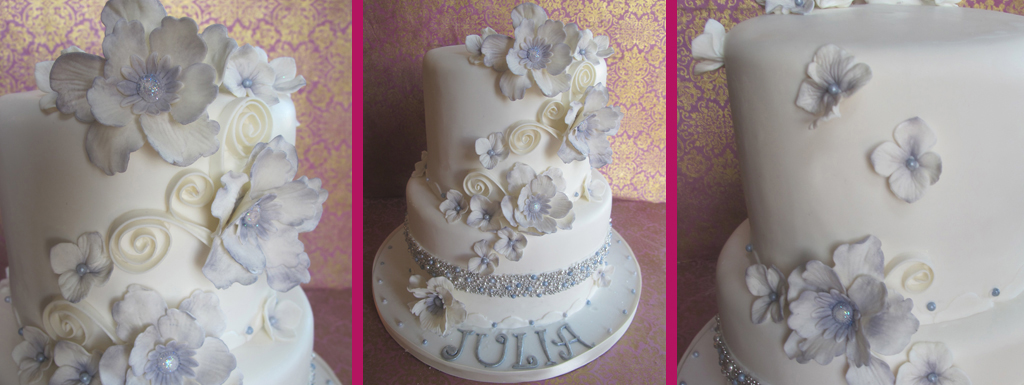 White cake with mauve accents and white fantasy sugar flowers